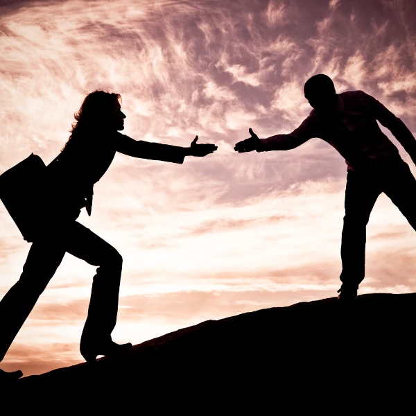 Two professionals reaching out to shake hands