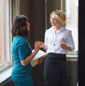 Two female professionals in a collaborative discussion.
